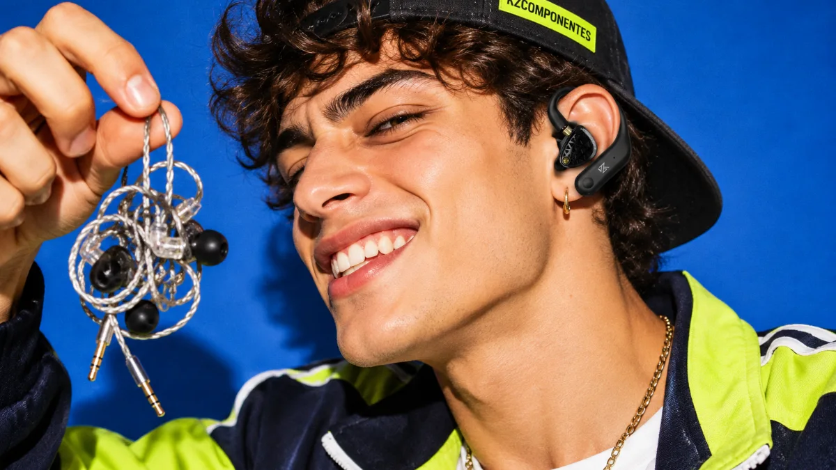 Man wearing a KZ Bluetooth adapter holding a tangled cable